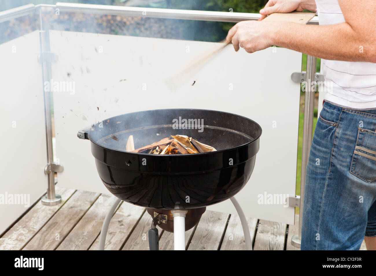 Grill master when igniting the fire of the grill Stock Photo