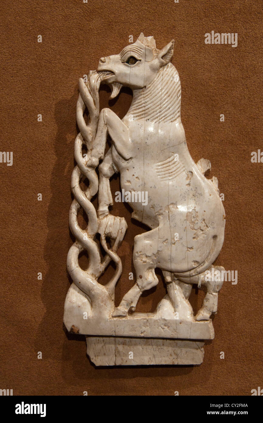 Plaque Ivory rampant goat eating a plant Neo Assyrian 8th century B.C.Mesopotamia Nimrud Kalhu  Assyria 16cm Stock Photo