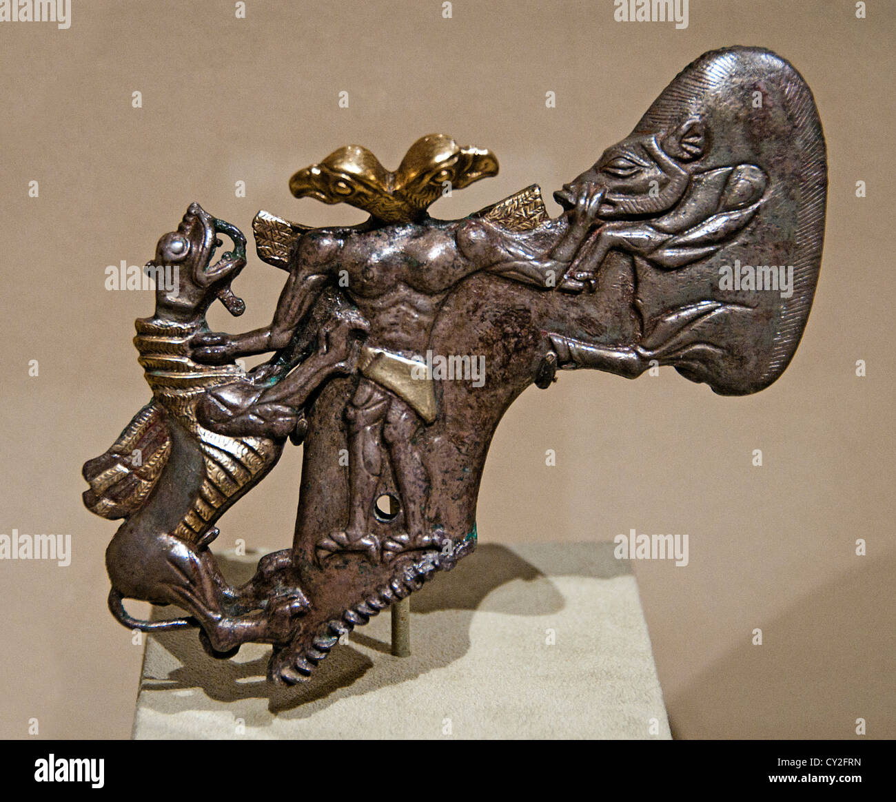Shafthole axe head bird headed demon boar dragon Bronze Age 3– 2 millennium BC Bactria Margiana Silver gold 15 cm  Uzbekistan Stock Photo