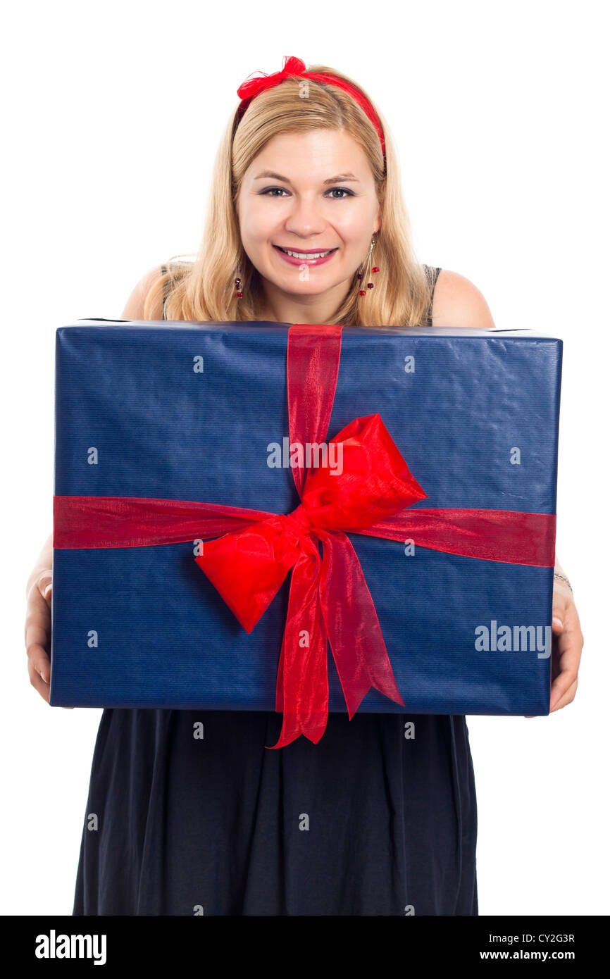 Happy woman holding big blue gift box, isolated on white background. Stock Photo