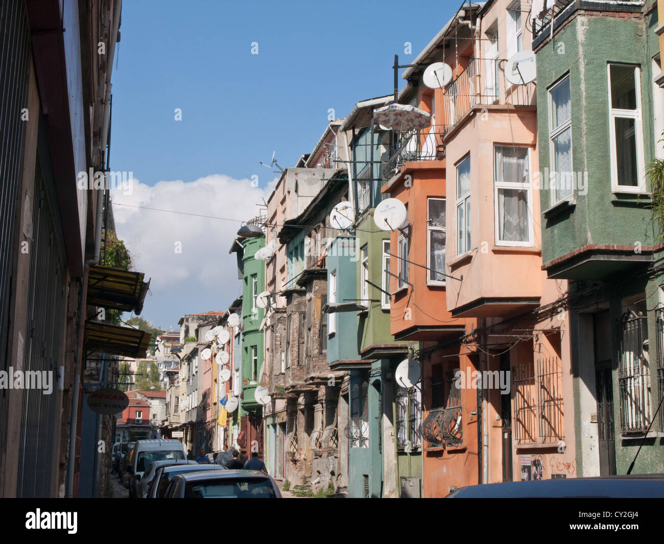 Row of traditional Turkish houses , top floors protruding over the pavement balconies and satelite dishes, Balat Istanbul Turkey Stock Photo