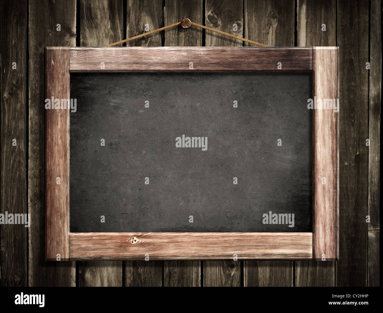 Grunge small blackboard hanging on wooden wall as a background for your message Stock Photo