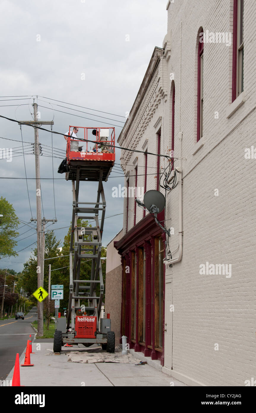 Scissor lift used to paint building Stock Photo Alamy