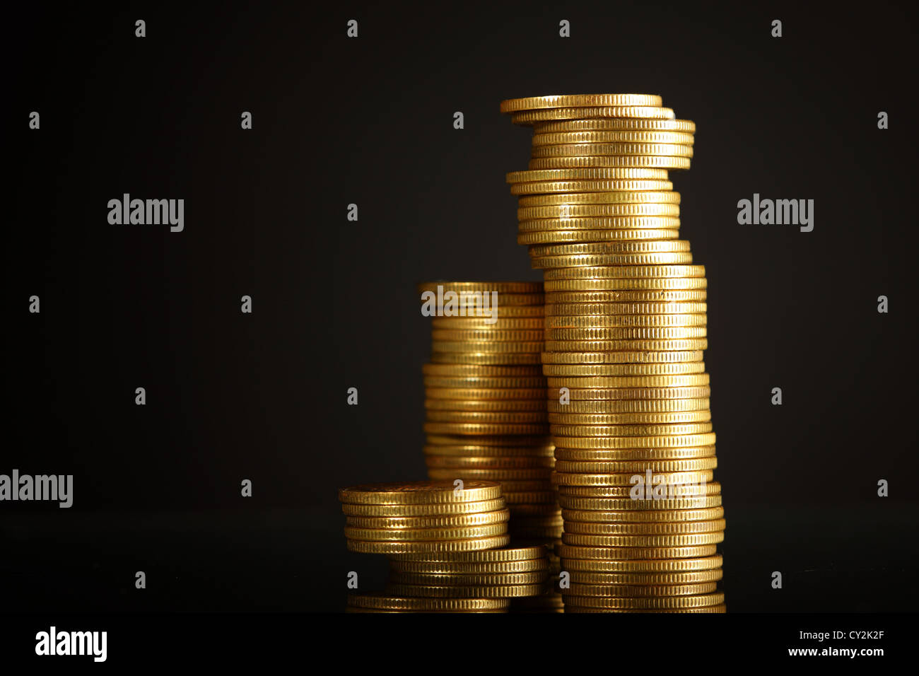 golden coins on black background Stock Photo - Alamy