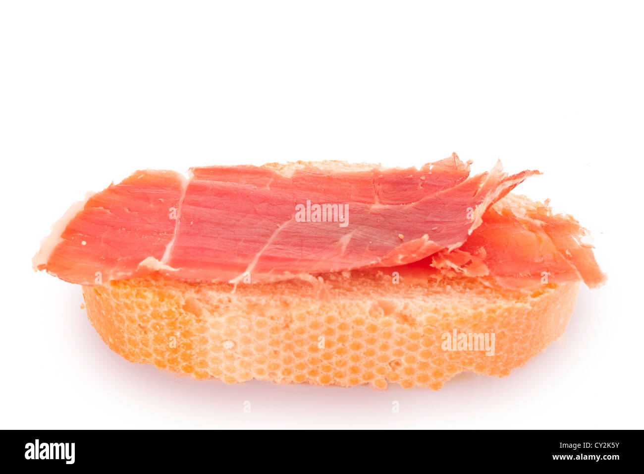 Iberian ham portion with bread, typical spanish 'tapa'. Stock Photo