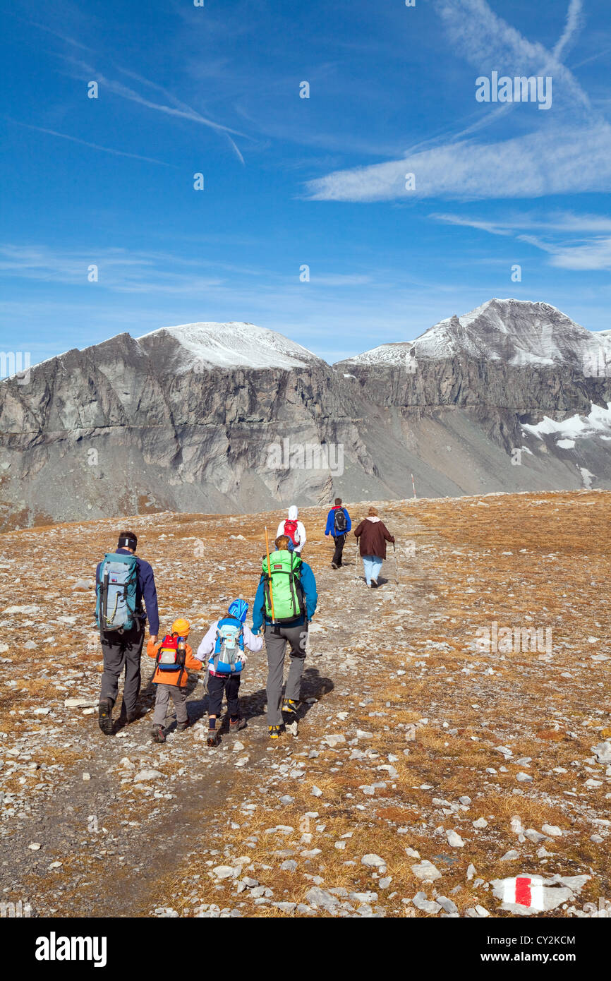 A family walking in the Swiss Alps mountains in autumn, at Flims Graubunden Switzerland Europe Stock Photo