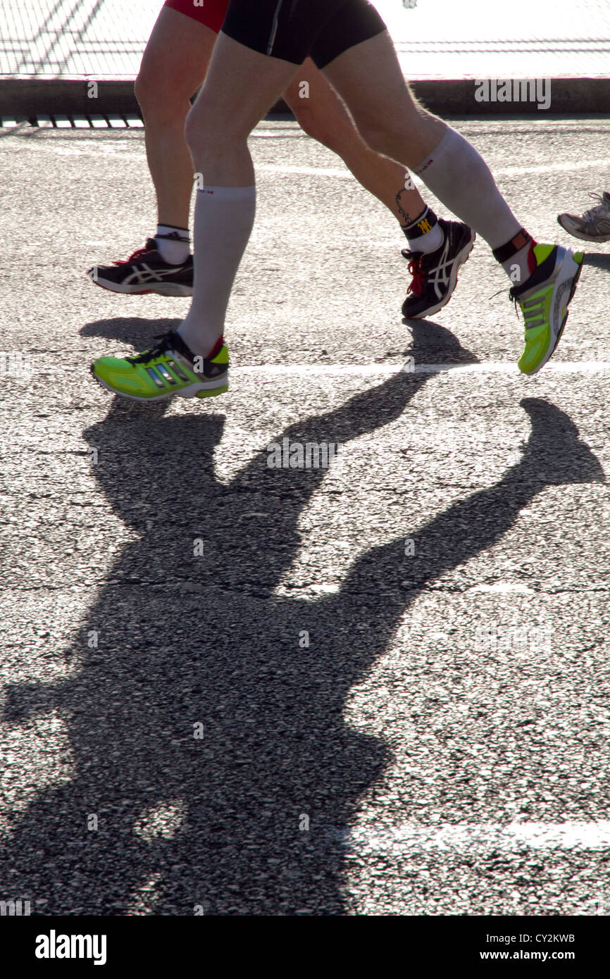 runners legs shadow on road athletes Marathon running Stock Photo Alamy