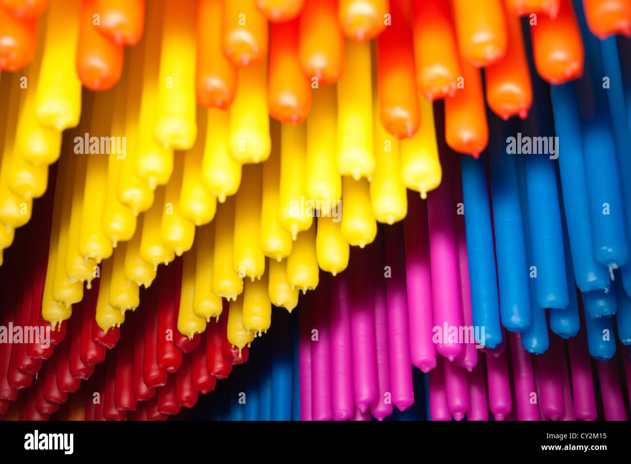Brightly colored candles hanging in factory at Nimbin Australia. Stock Photo