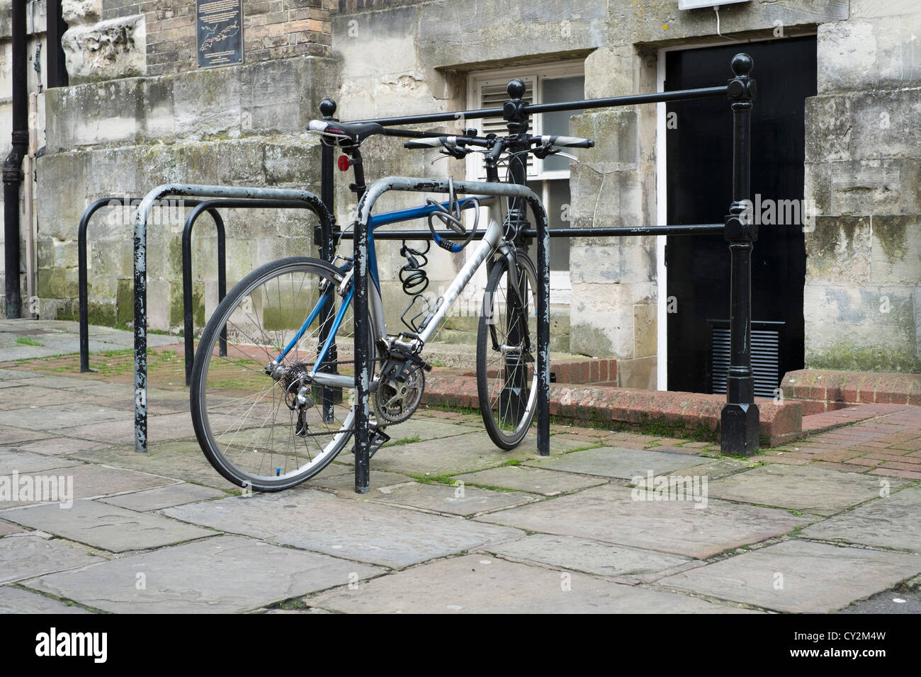 Security Rails For Cycles Expensive bicycle securely locked to steel railing Stock Photo - Alamy