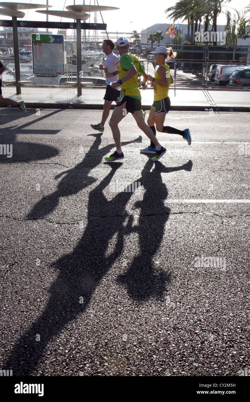 Marathon runners shadows on road race athletes running Palma de Mallorca Spain 2012 Stock Photo