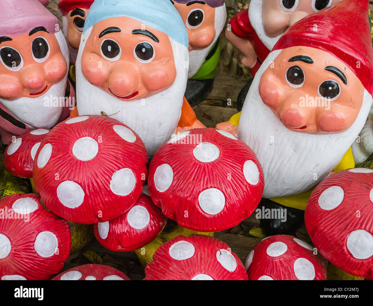 A group of trolls and mushrooms for sale as kitsch lawn art at a street market in Asunción Paraguay. Stock Photo