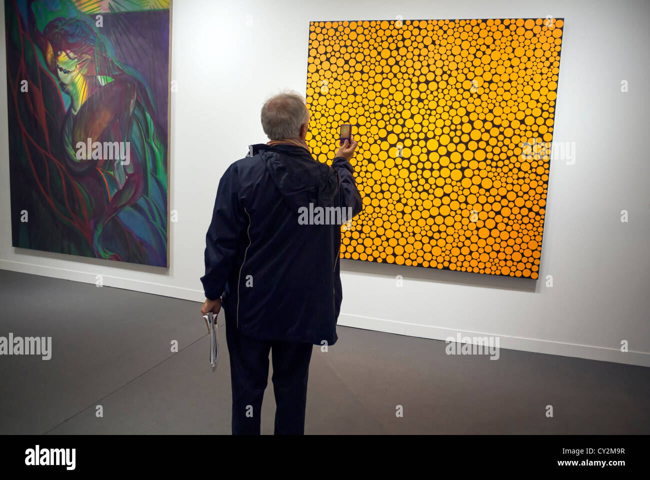 Paris, France, Europe, A senior caucasian snapping 'Infinity-Dots Asnih' by Yahoo KUSAMA at Fiac 2012 Stock Photo