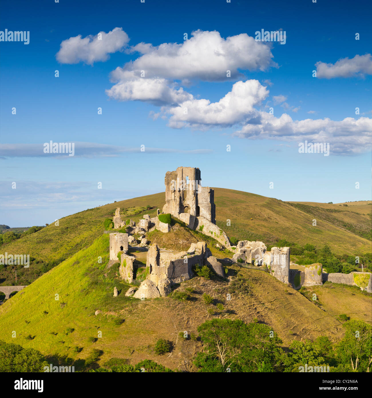 Corfe Castle on its hill above the beautiful Dorset countryside, on a lovely summer afternoon. Stock Photo