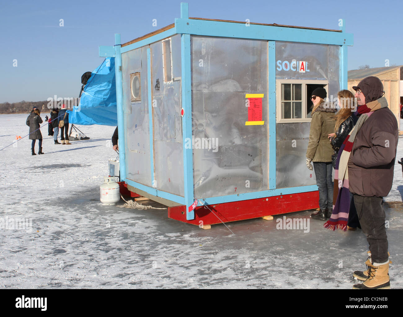 People standing around at the Art Shanty Project in Minneapolis. Stock Photo
