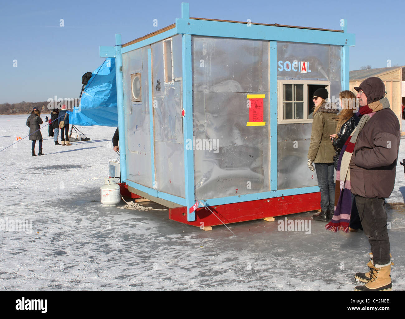 People standing around at the Art Shanty Project in Minneapolis Stock