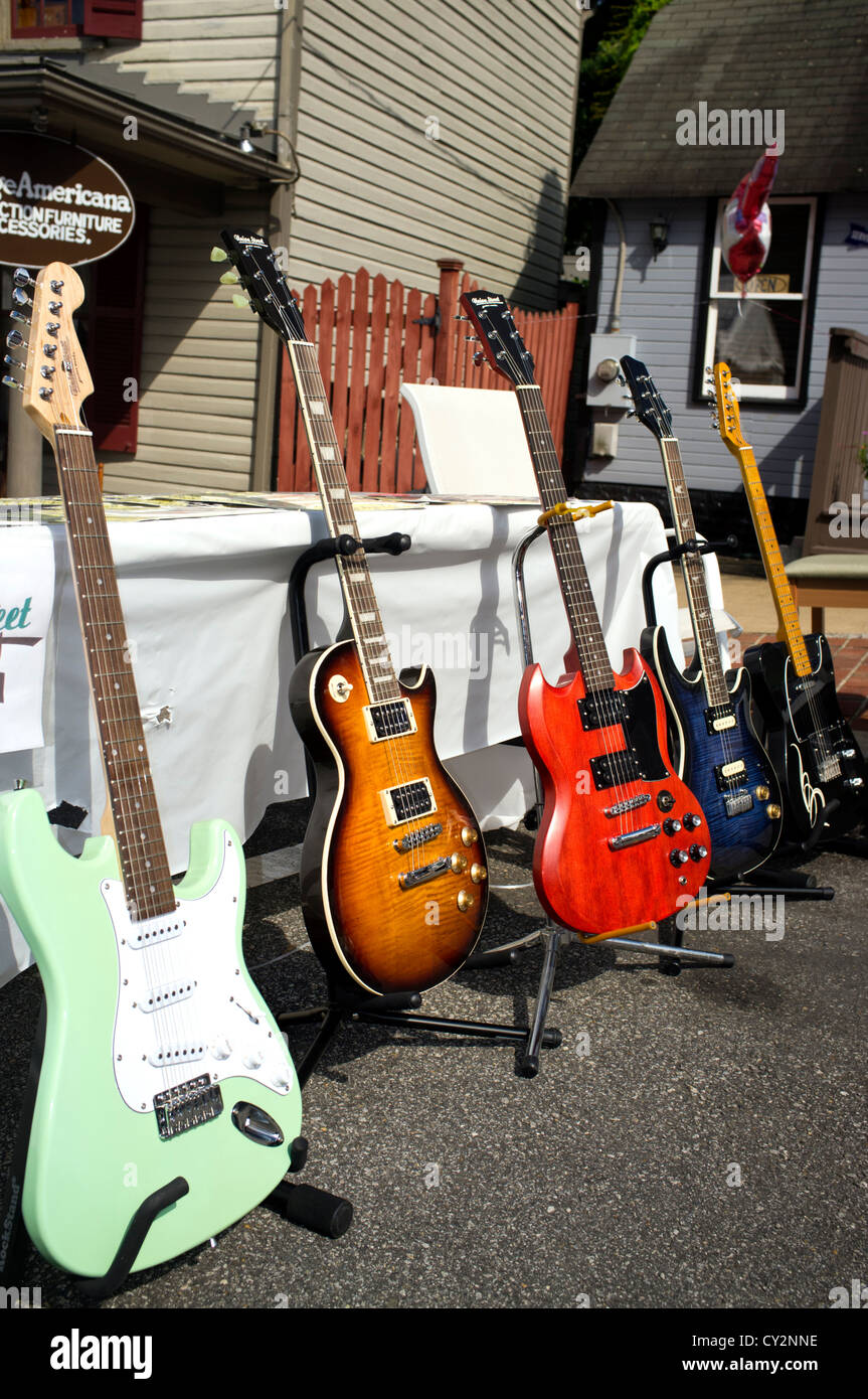 Guitars sitting on stands outdoors Stock Photo