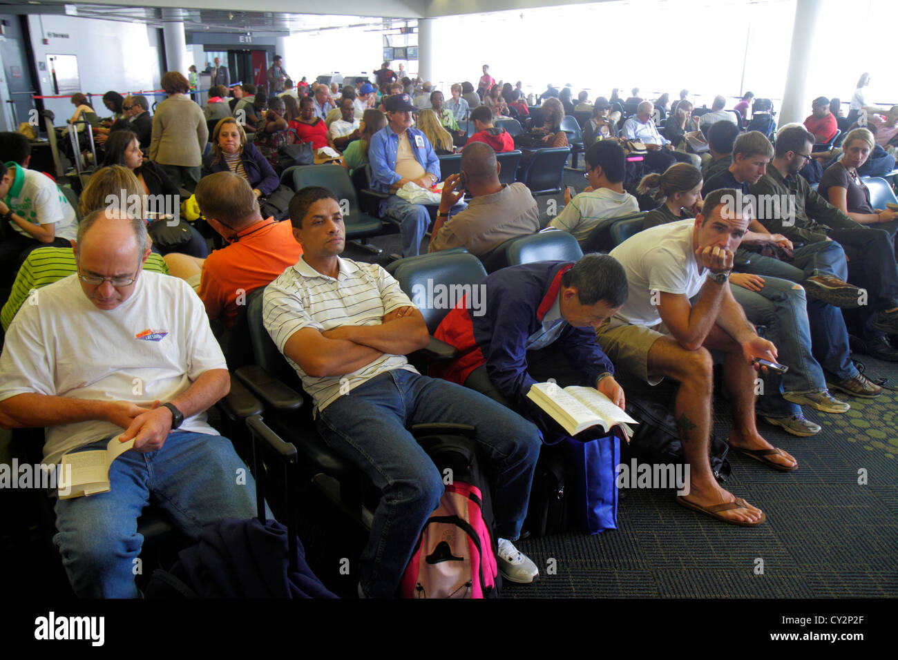 Miami Florida International Airport MIA,gate,passenger passengers rider riders,man men male,woman female women,Hispanic crowded,waiting,delays,FL12081 Stock Photo
