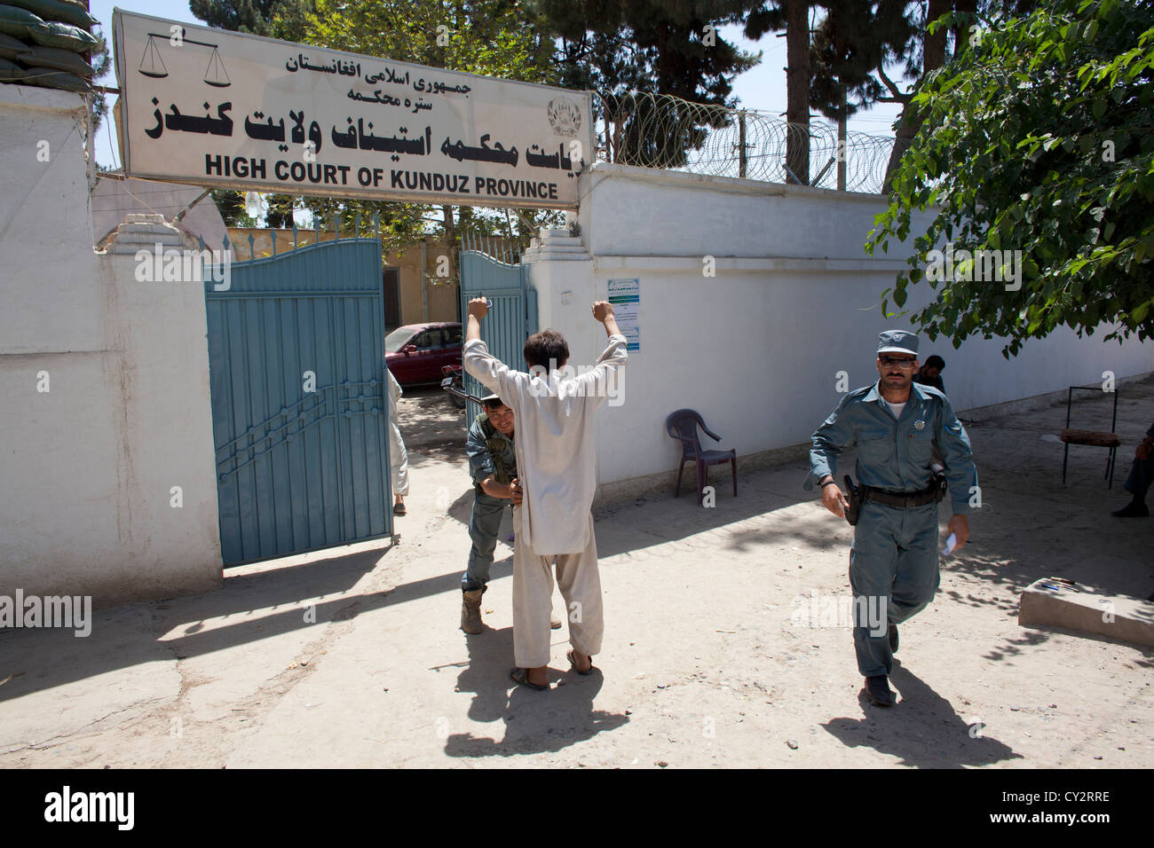 Afghan police secures the entrance of the high court in Kunduz. Stock Photo