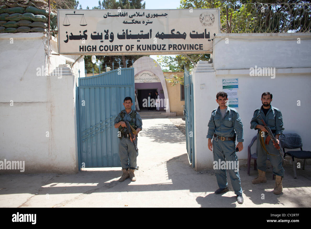 Afghan police secures the entrance of the high court in Kunduz. Stock Photo