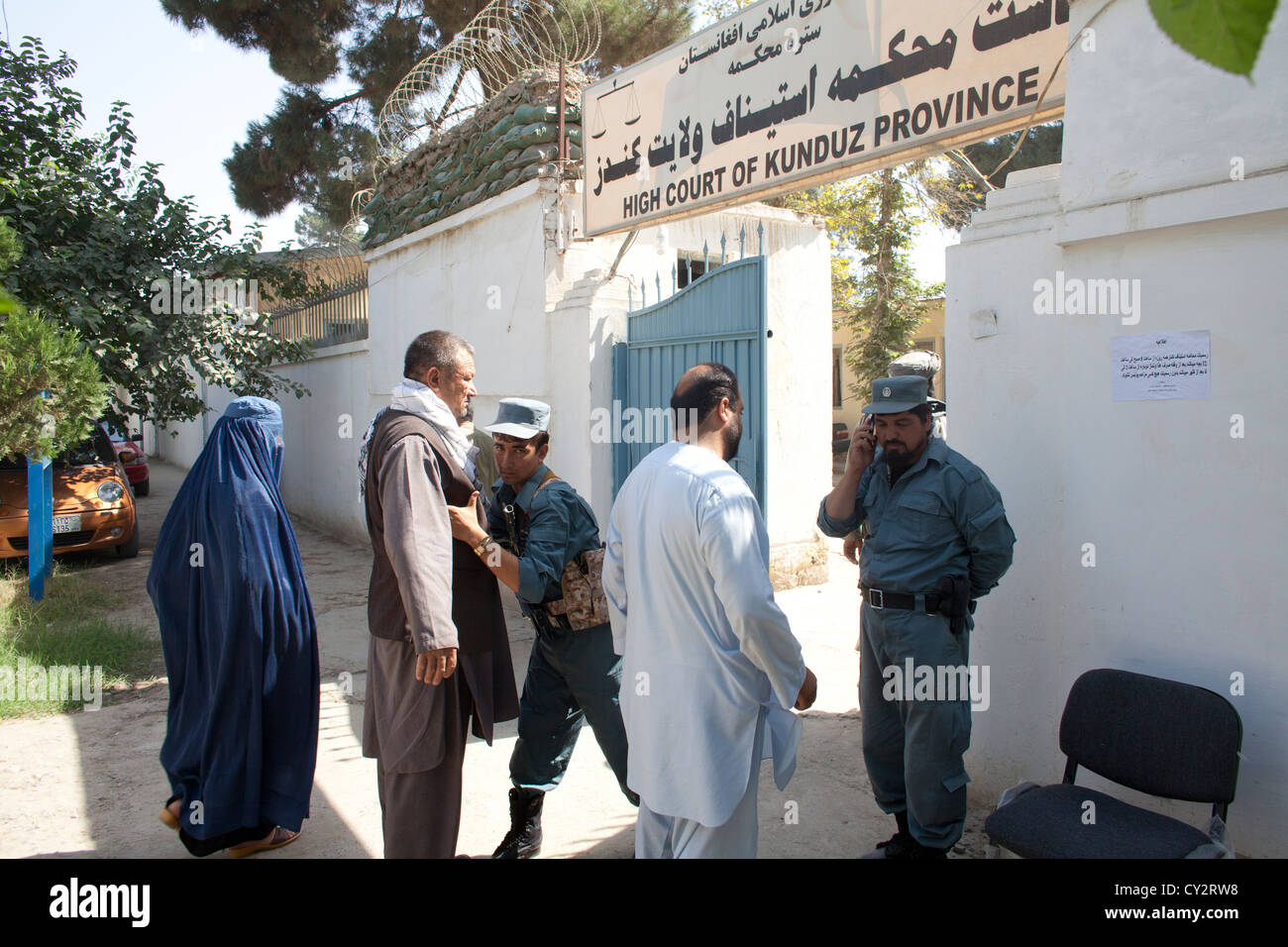 Afghan police secures the entrance of the high court in Kunduz. Stock Photo
