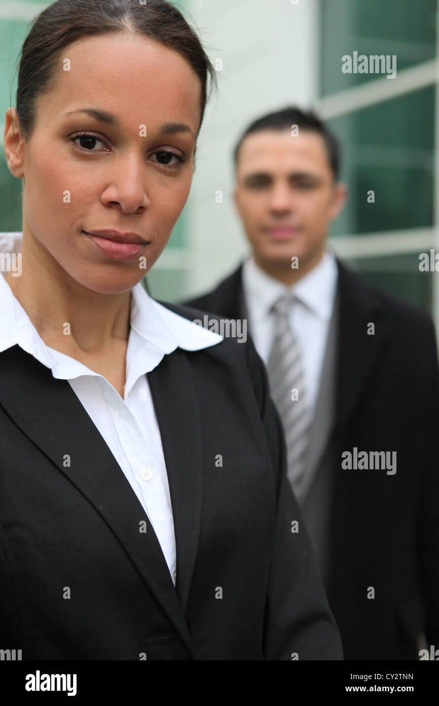 Young business couple stood in front of their office Stock Photo - Alamy
