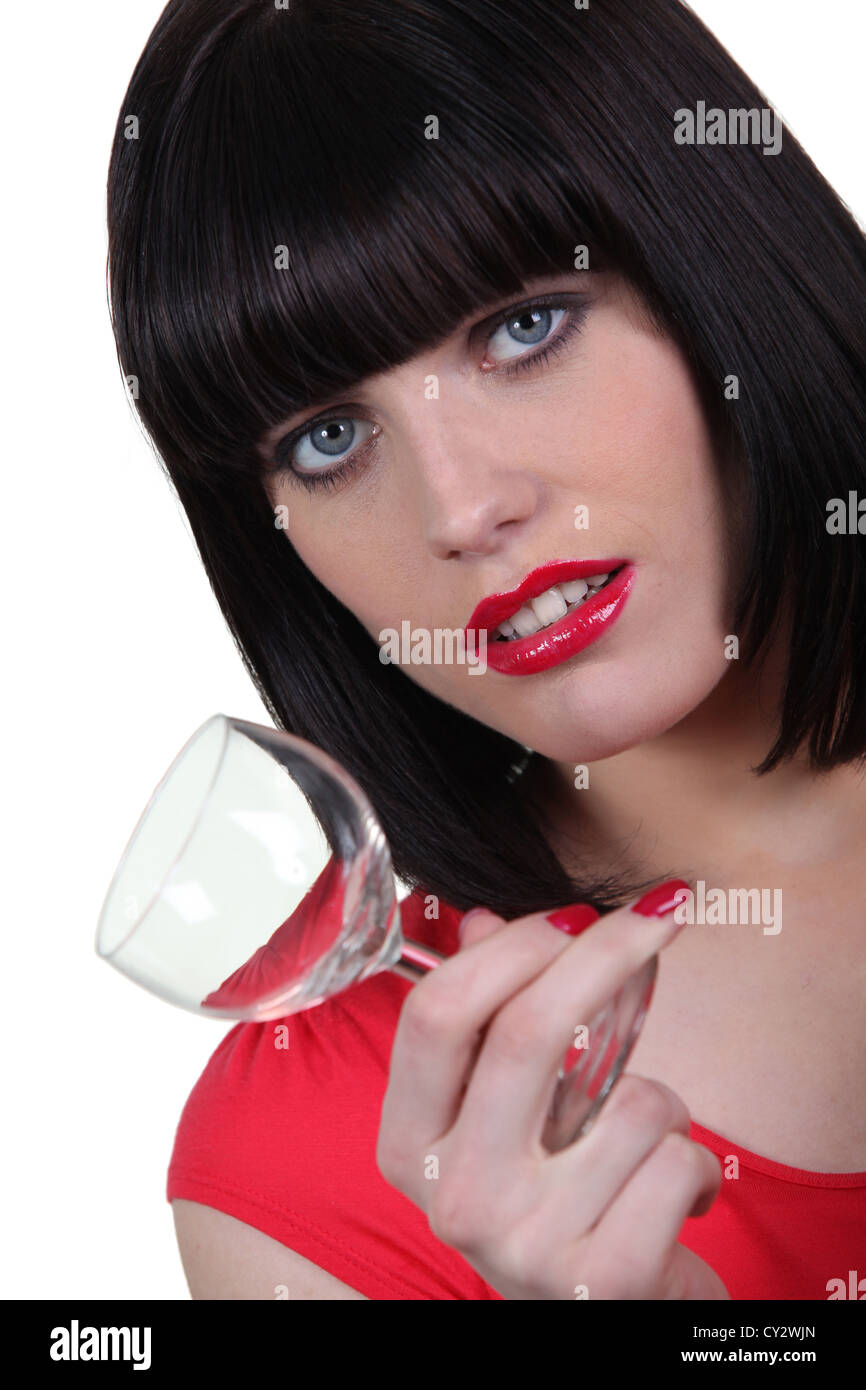 Brunette woman with glass in hand Stock Photo - Alamy