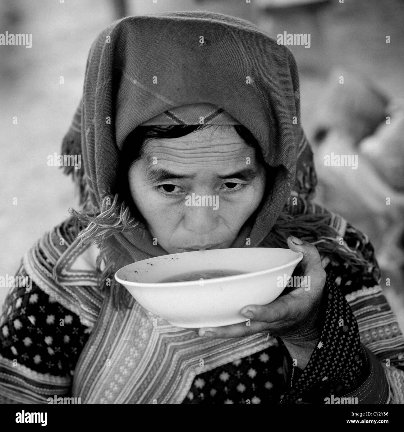 Flower Hmong Woman Drinking A Bowl Of Soup, Sapa Market, Vietnam Stock Photo