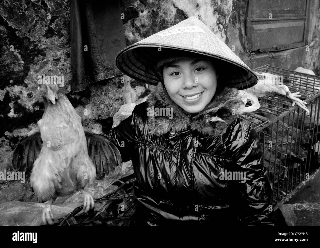 Woman With A Sedge Hat Showing A Chicken She Sells, Sapa, Vietnam Stock Photo