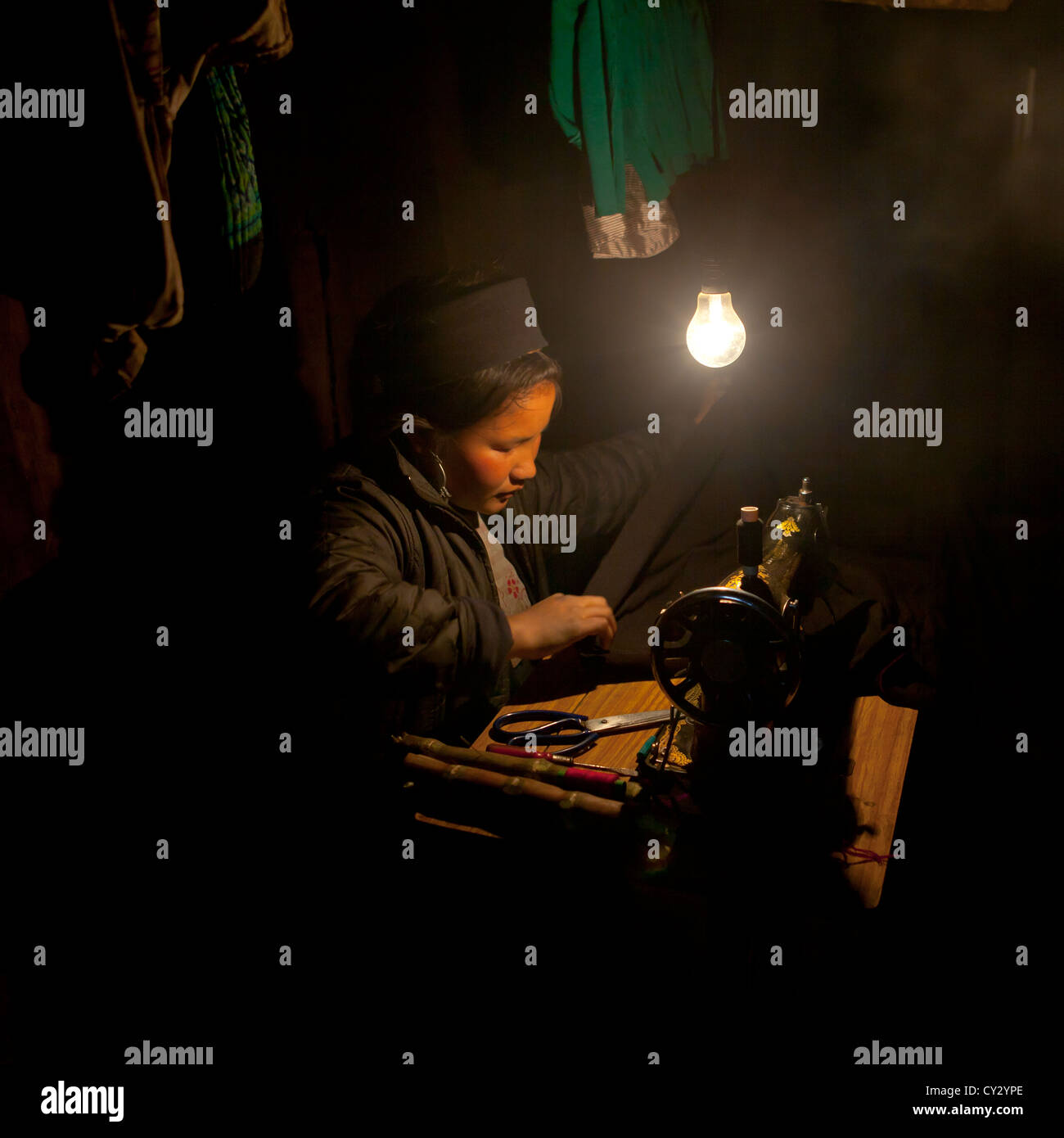 Black Hmong Girl On A Sewing Machine, Sapa, Vietnam Stock Photo