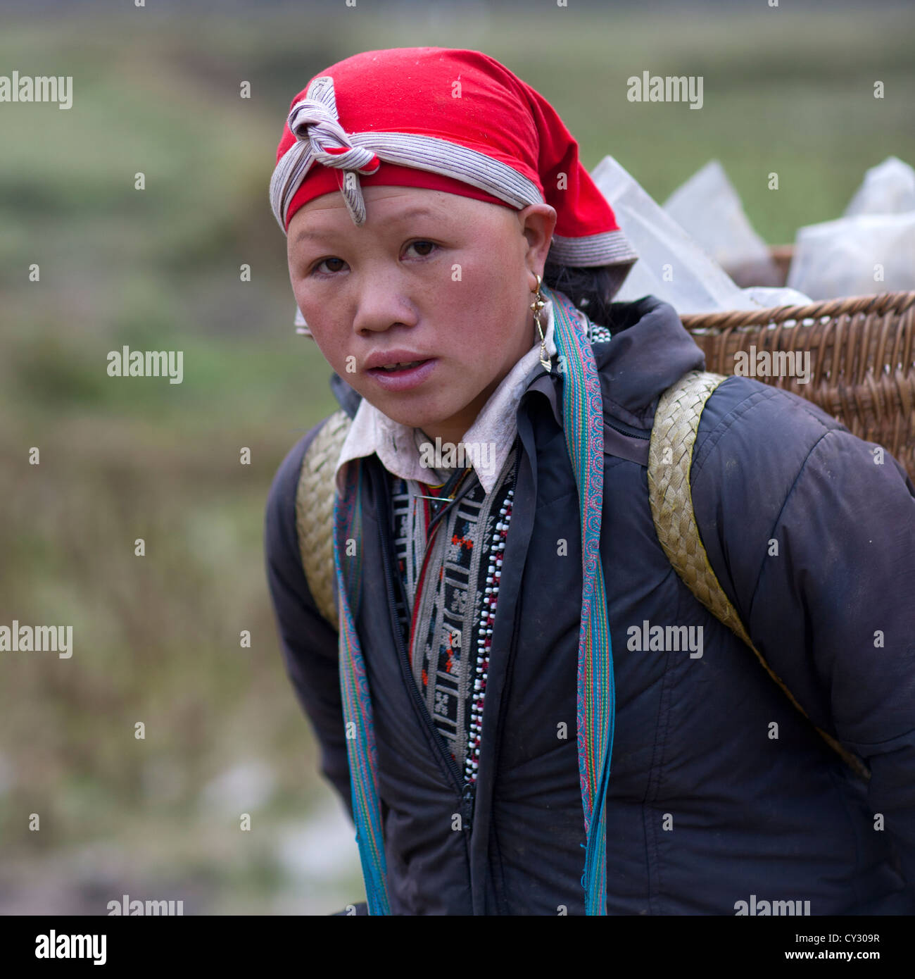 Red Dzao Woman Carrying A Basket On Her Shoulders, Sapa, Vietnam Stock Photo