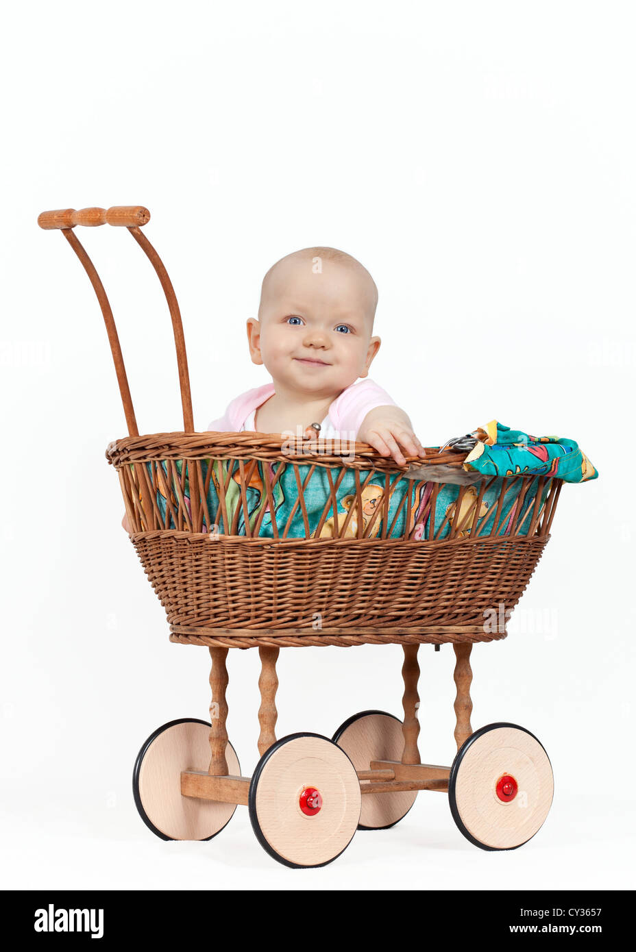 Young baby girl in a wicker pram Stock Photo