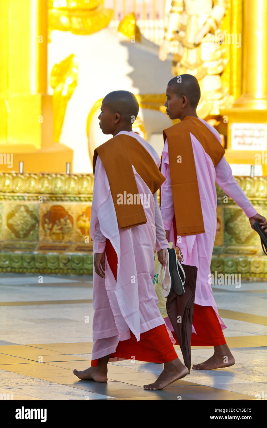 Buddhist Nuns walking around the Shwedagon Pagoda in Rangoon, Myanmar