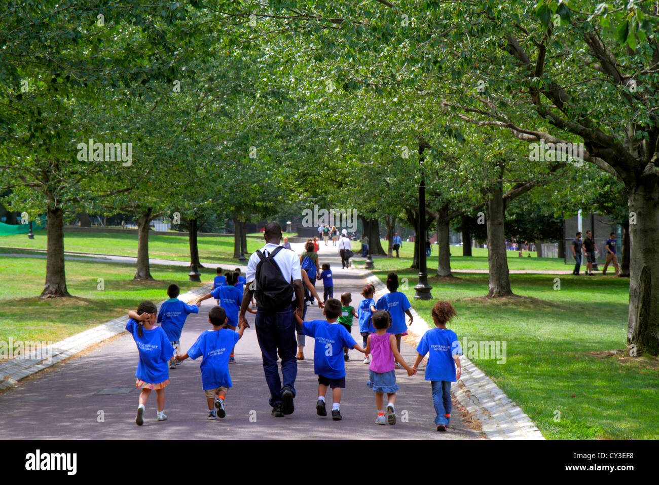 Boston Massachusetts,Boston Common,public park,daycare,day care,class,Black man men male adult adults,boy boys,kid kids child children youngster,girl Stock Photo