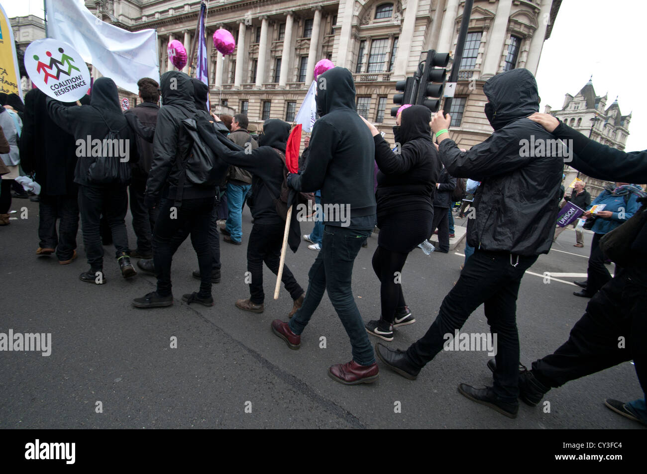Black Bloc activists try to confuse the police as they weave their way through the TUC march on 20th October 2012 Stock Photo