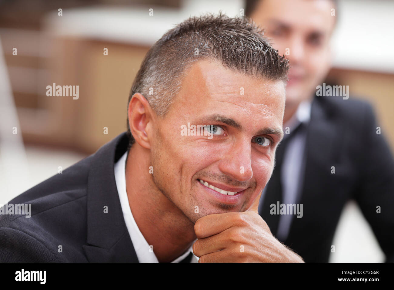 Serious mature businessman in business meeting at office, looking at ...