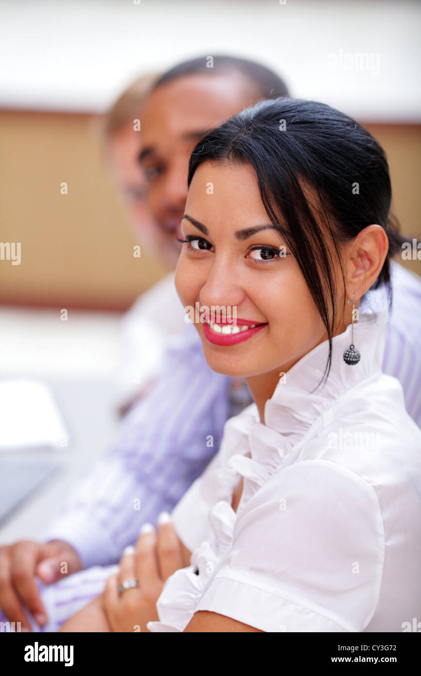 Smiling latin business woman looking at camera with satisfaction and ...