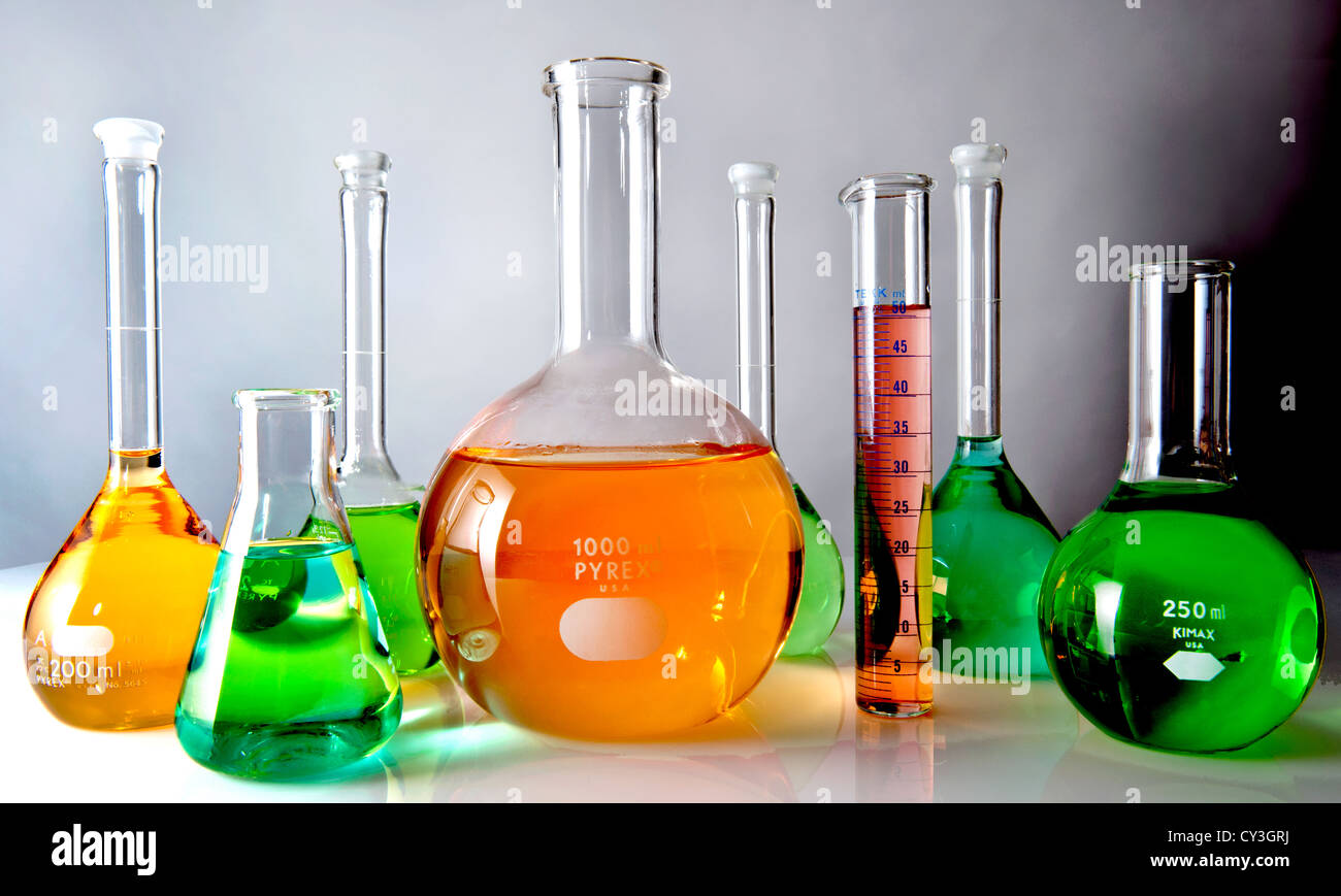 Glass lab flasks filled with colored liquids. Stock Photo