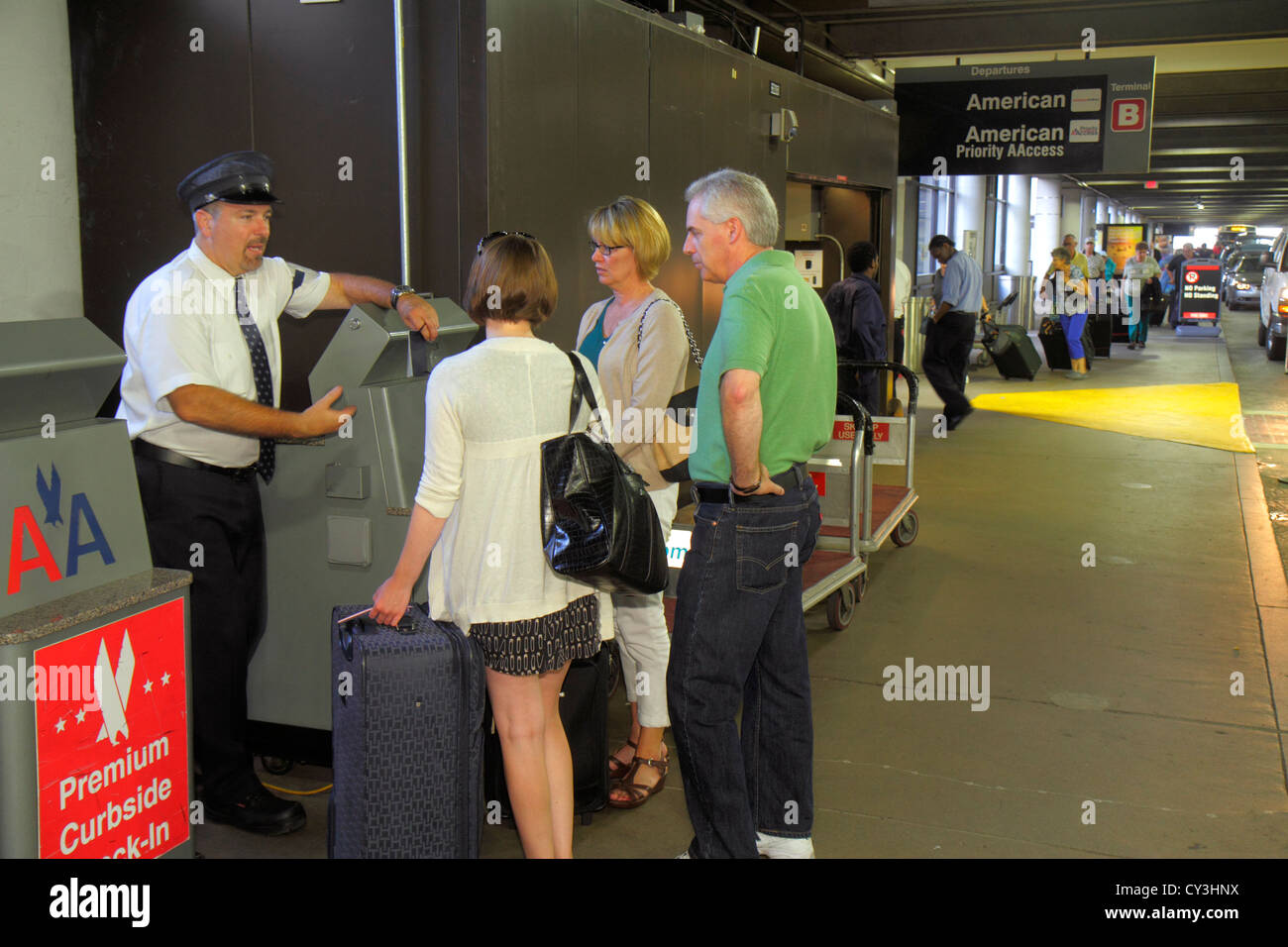 Boston Massachusetts,Logan International Airport,BOS,curbside check in,American Airlines skycap,explaining,adult adults man men male,woman women femal Stock Photo
