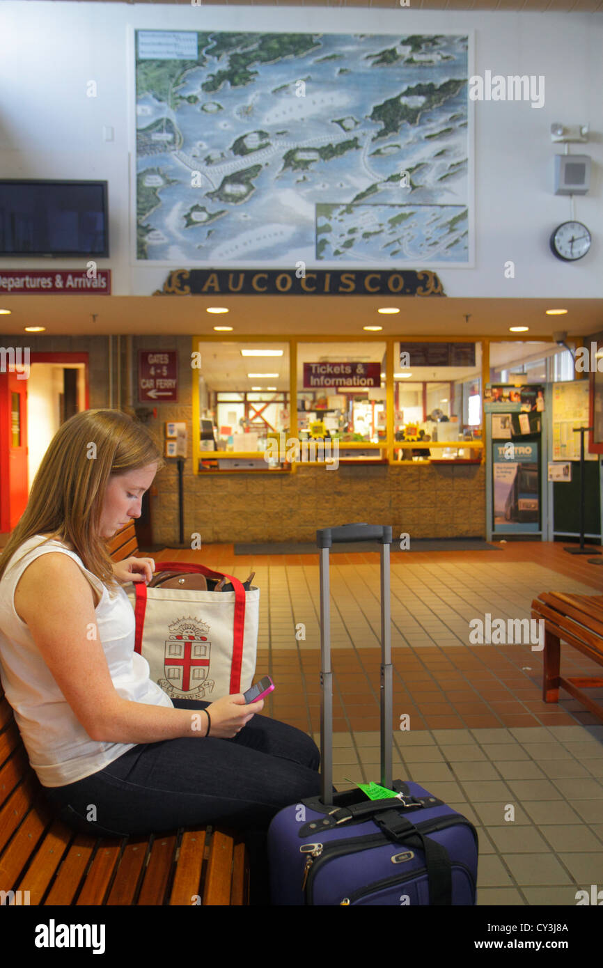 Portland Maine,historic Old Port District,Maine State Pier,Casco Bay Lines Ferry Terminal,woman female women,waiting,luggage,suitcase,ME120824027 Stock Photo