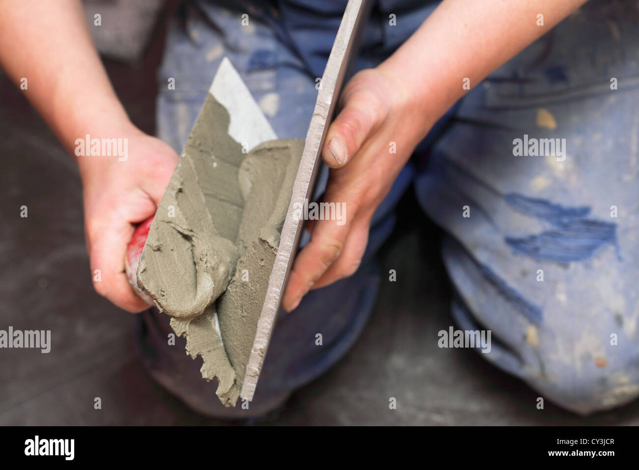 Construction worker is tiling at home tile floor adhesive Stock Photo ...