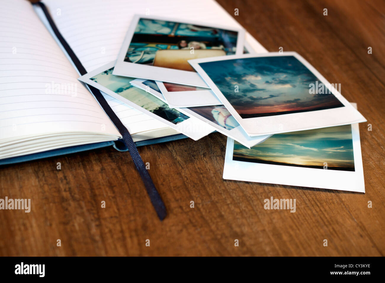 Vintage polaroid pictures and an open journal Stock Photo Alamy