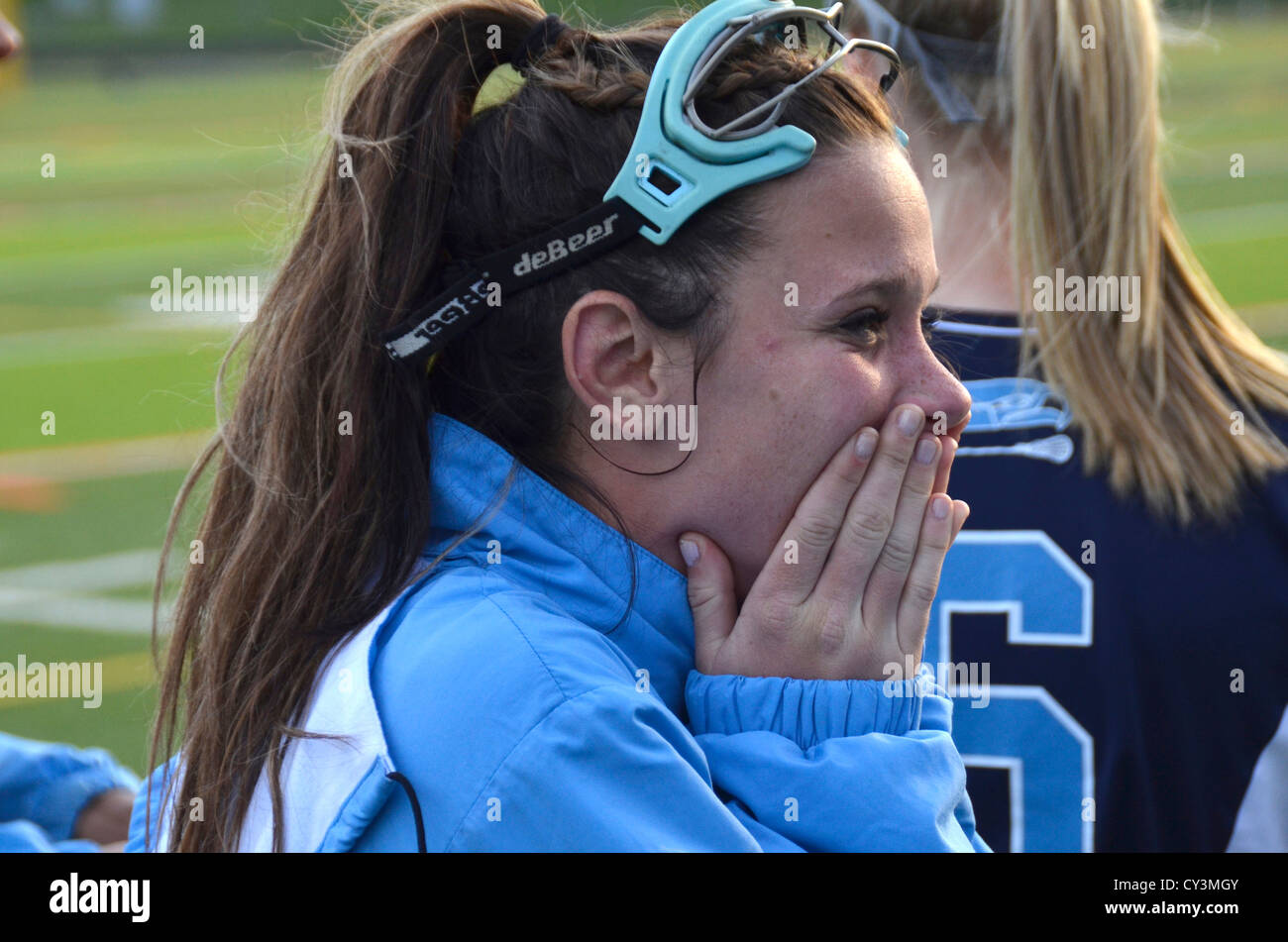 Lacrosse player reacts after a teamamte score in a girls lacrosse game in Edgewater,Md Stock Photo