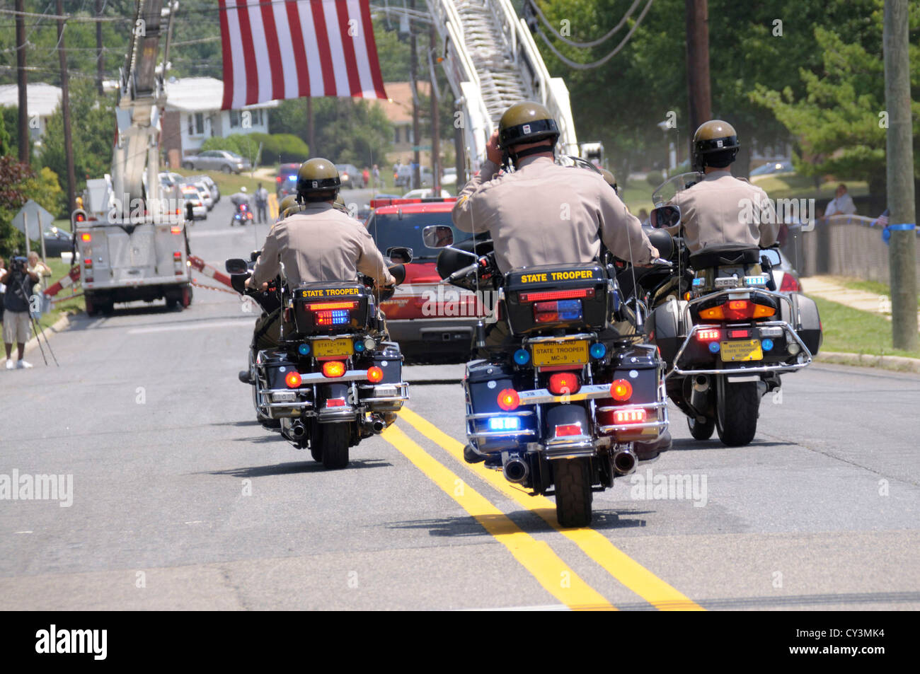 Police funeral escorted by state troopers on motorcycles Stock Photo