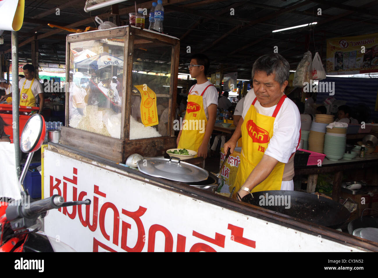 Chefs cooking Chinese vegetarian noodle at shop in Phuket vegetarian