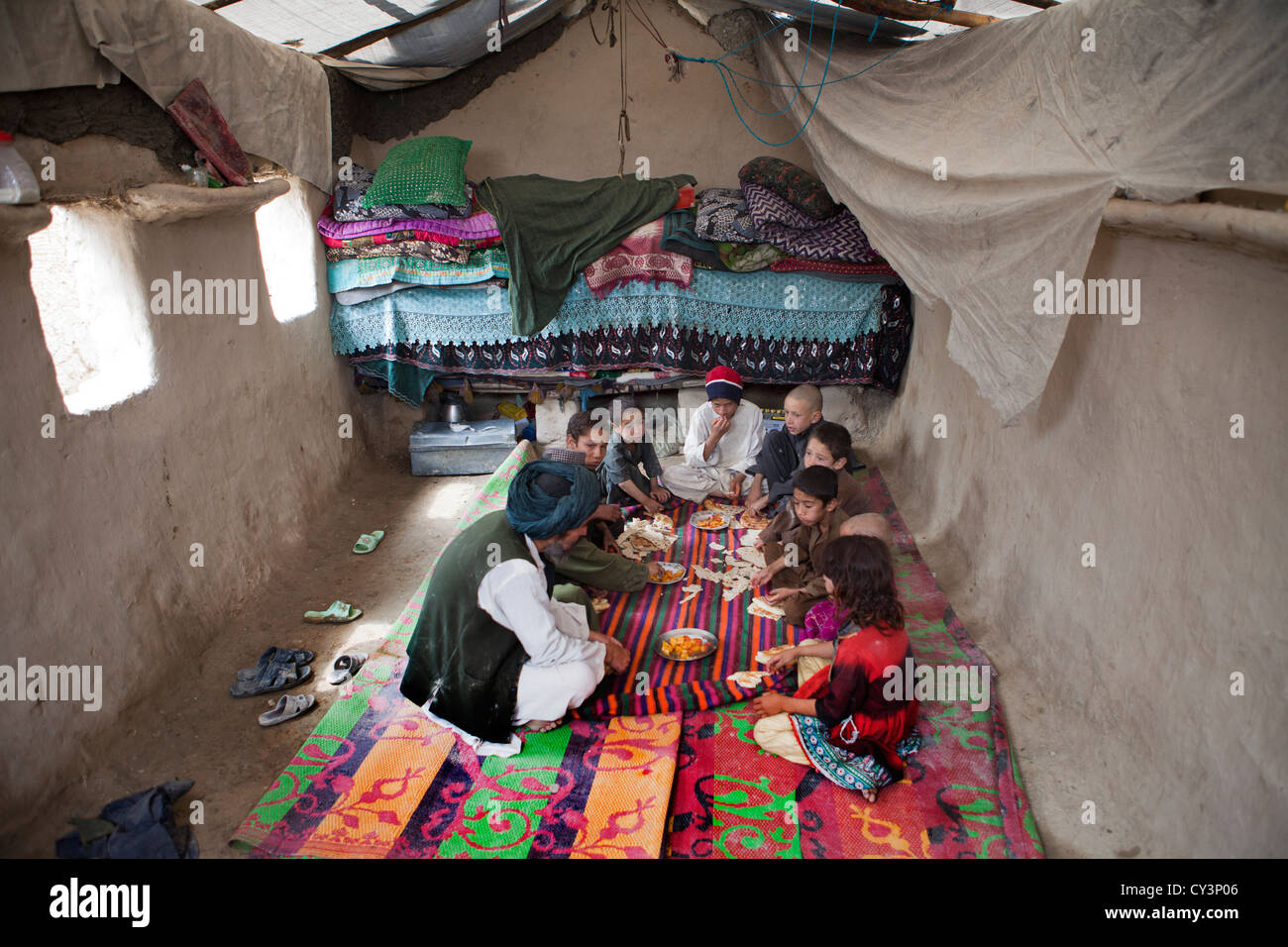 Afghan family having lunch in their mud house Stock Photo