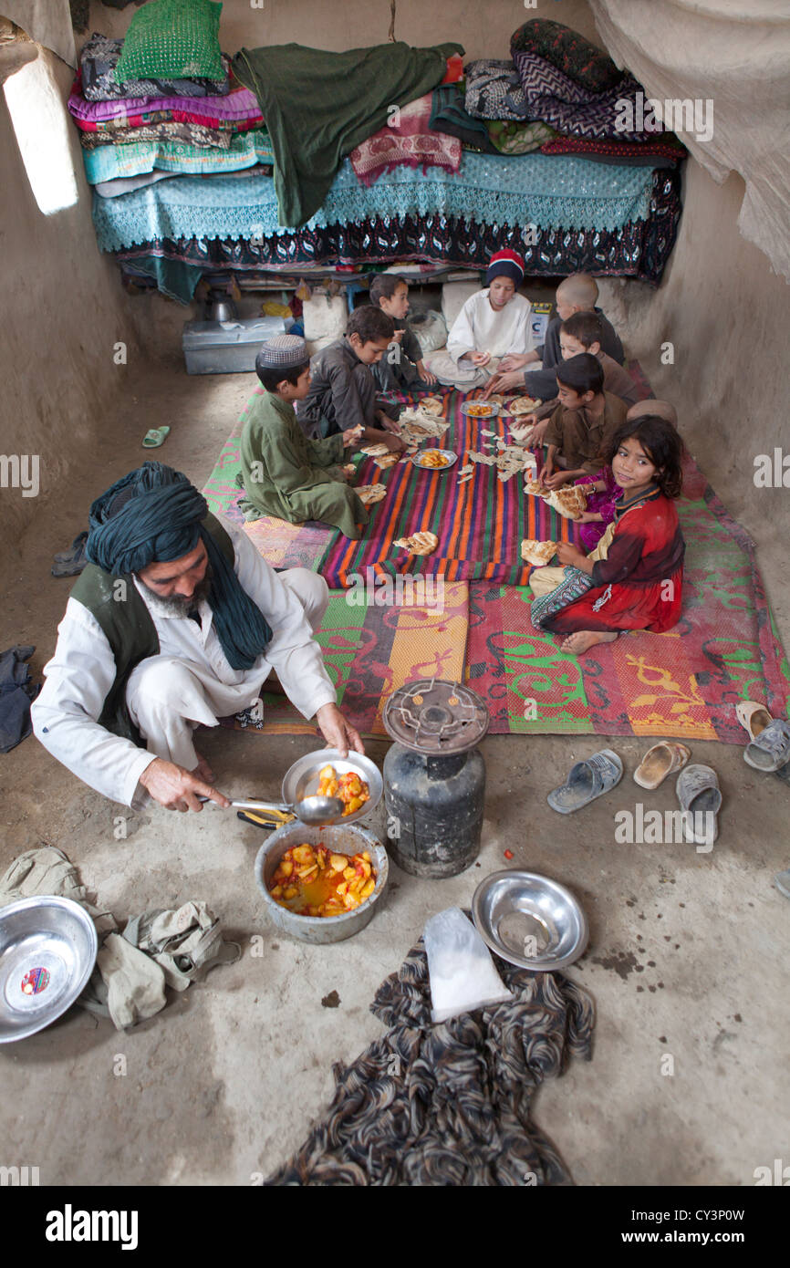 Afghan family having lunch in their mud house Stock Photo