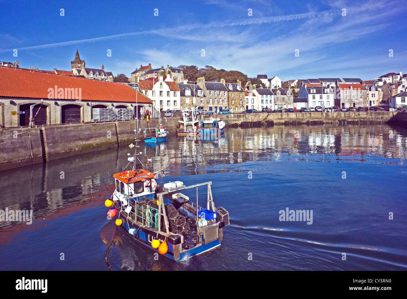 Fishing boat approaching the Fish Market in Pittenweem harbour East ...
