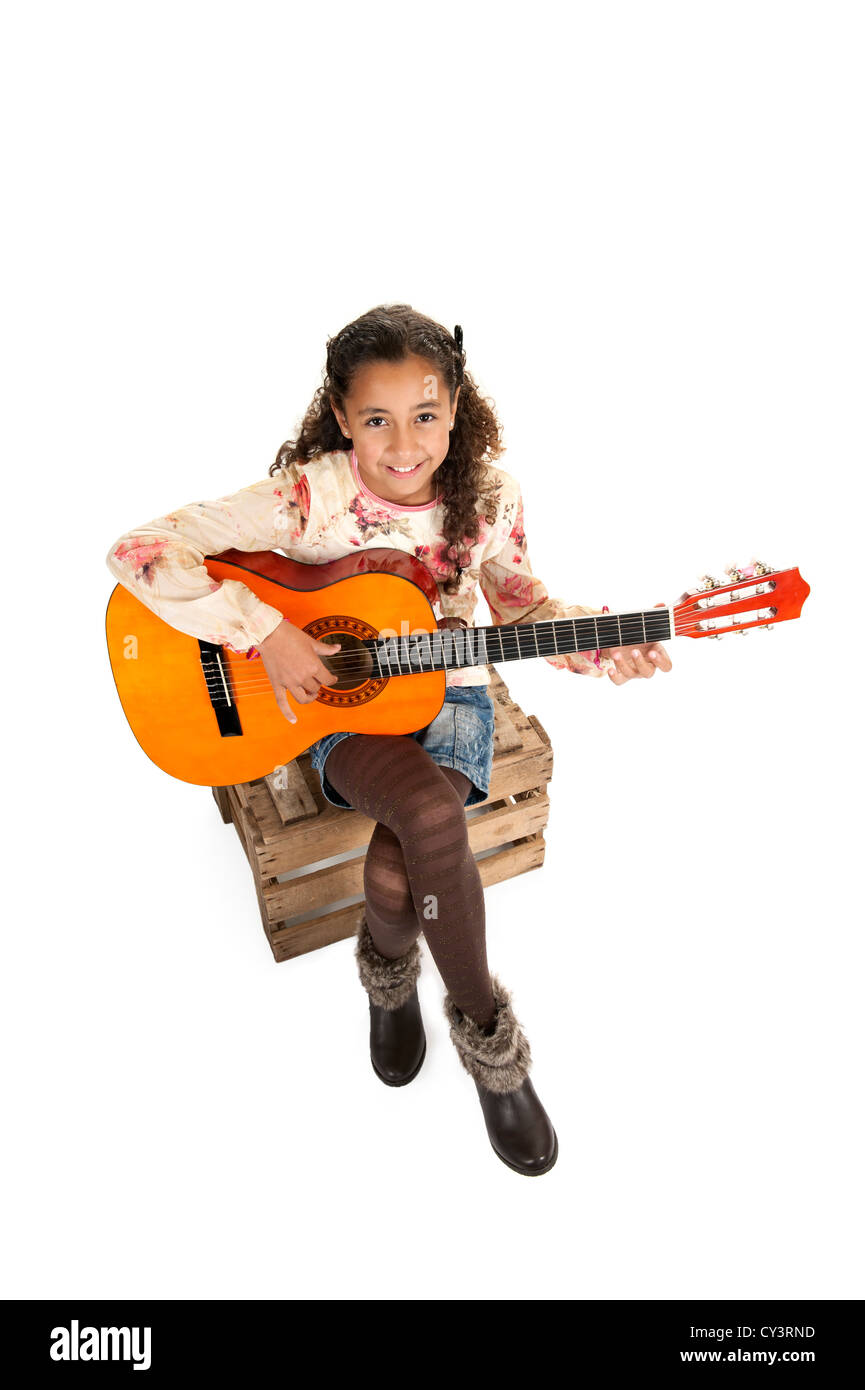 young girl playing the guitar, isolated on white Stock Photo