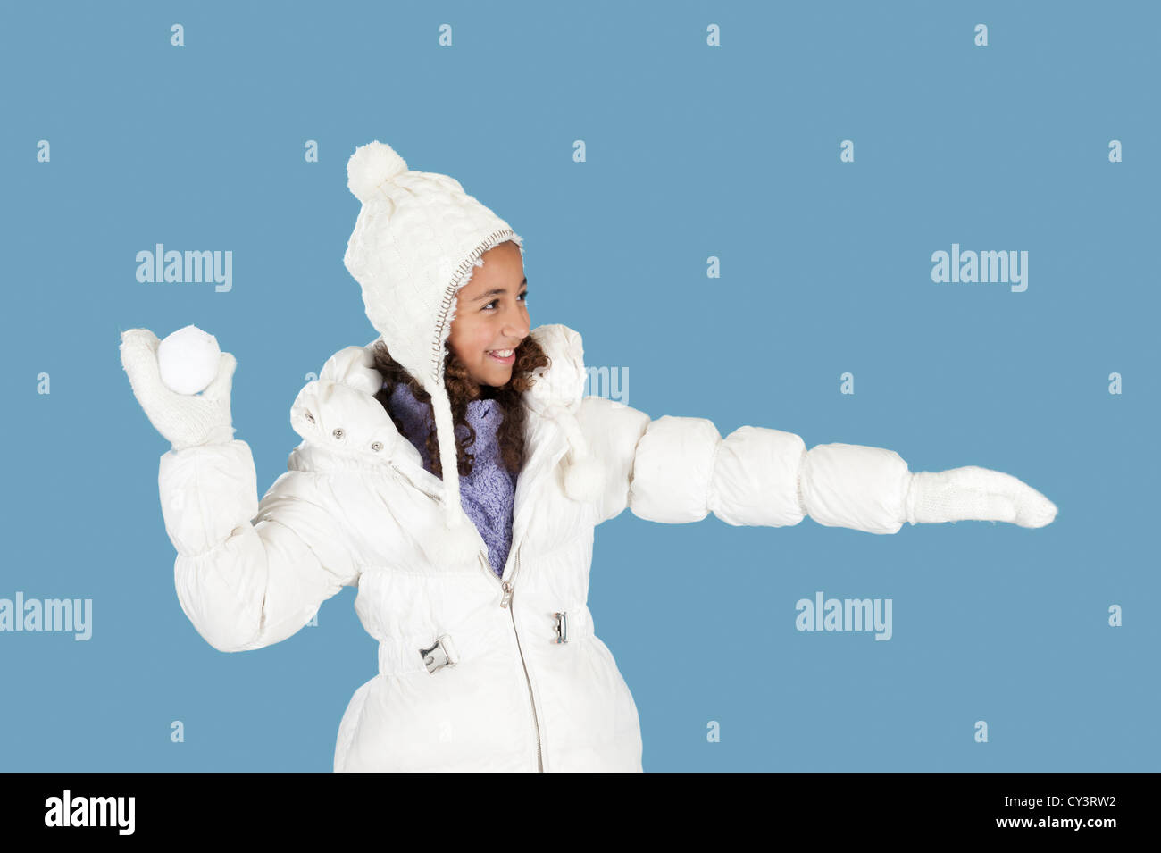 winter fun, girl throwing a snow ball Stock Photo