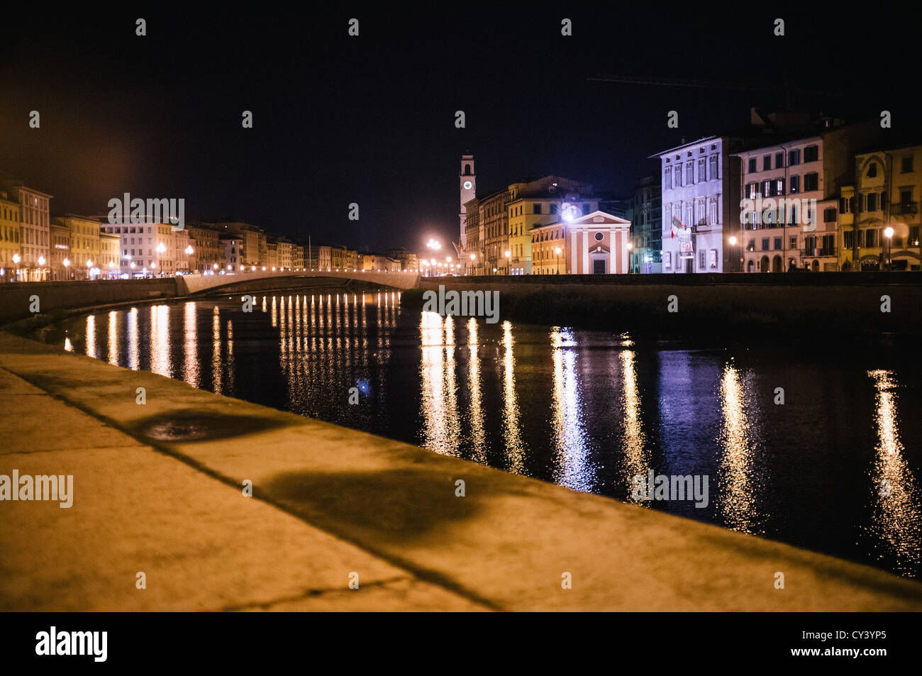The Ponte di Mezzo bridge in Pisa spanning the river Arno at night